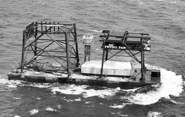 Photograph, 1964: components of the light station under tow on a barge en route to Frying Pan Shoals.